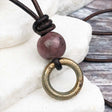 Thick Dark Golden Bronze Celtic Ring Money with Rhodonite Leather Necklace