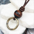 Gleaming Golden Bronze Celtic Ring Money with Red Tigers Eye Leather Necklace
