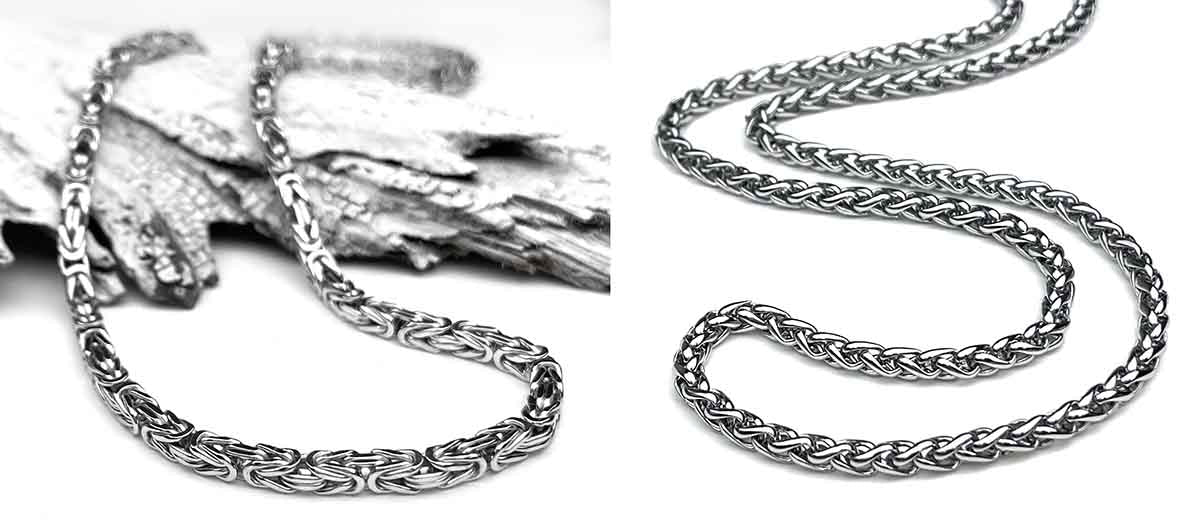 A Byzantine chain necklace rests on textured wood, highlighting its intricate, interlocking design in silver tones. The chain curves gracefully, showcasing its elegant craftsmanship.
